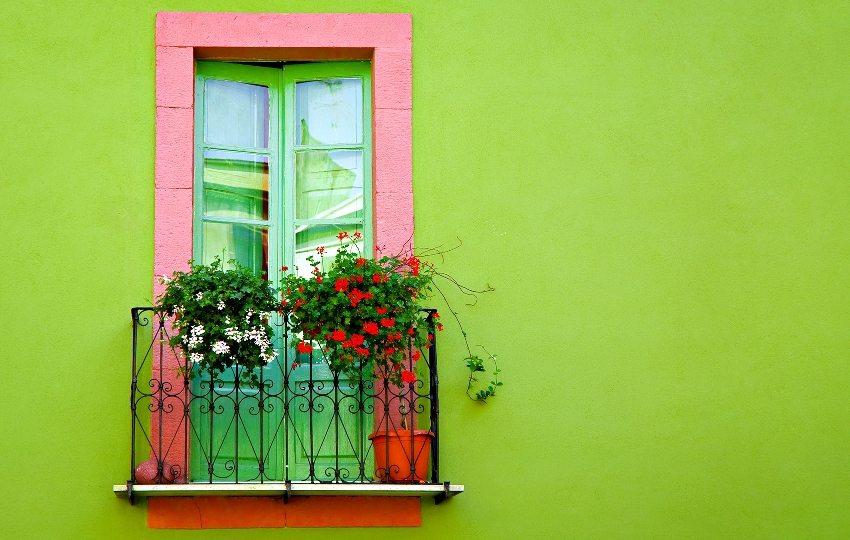 The facade of the house is painted in a bright lime color