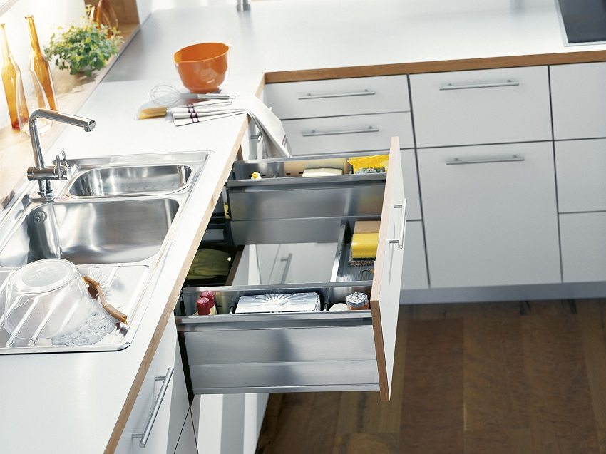 Functional pull-out drawers with a hole in the middle leave space for a food waste disposer