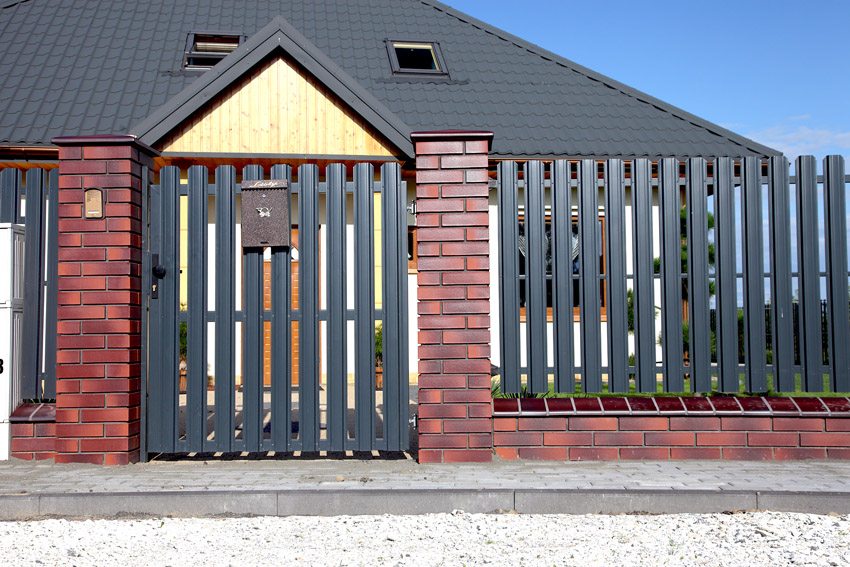 Fence made of metal picket fence with brick posts