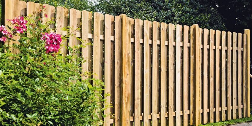 A wooden picket fence is installed in the form of a checkerboard