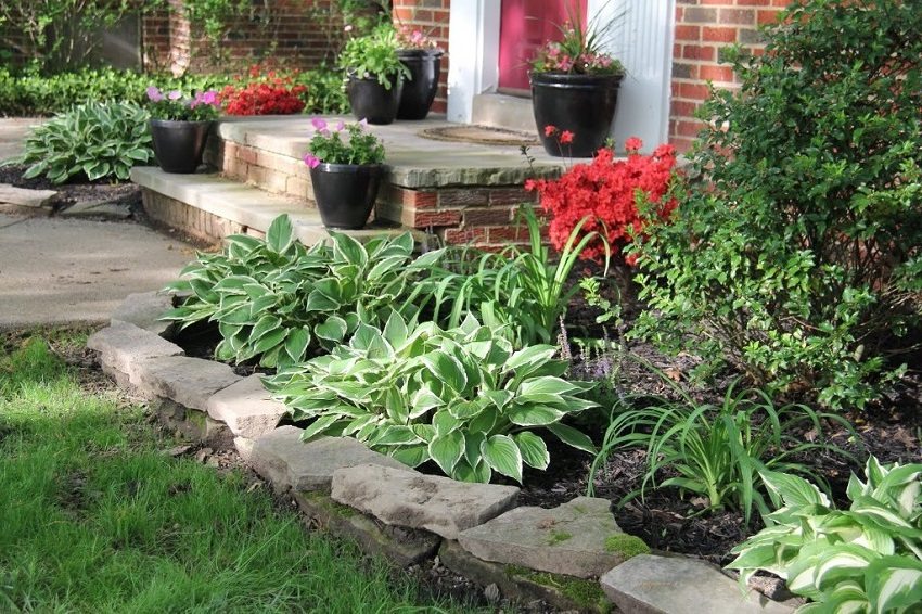 A small curb lined with stones separates the planting area