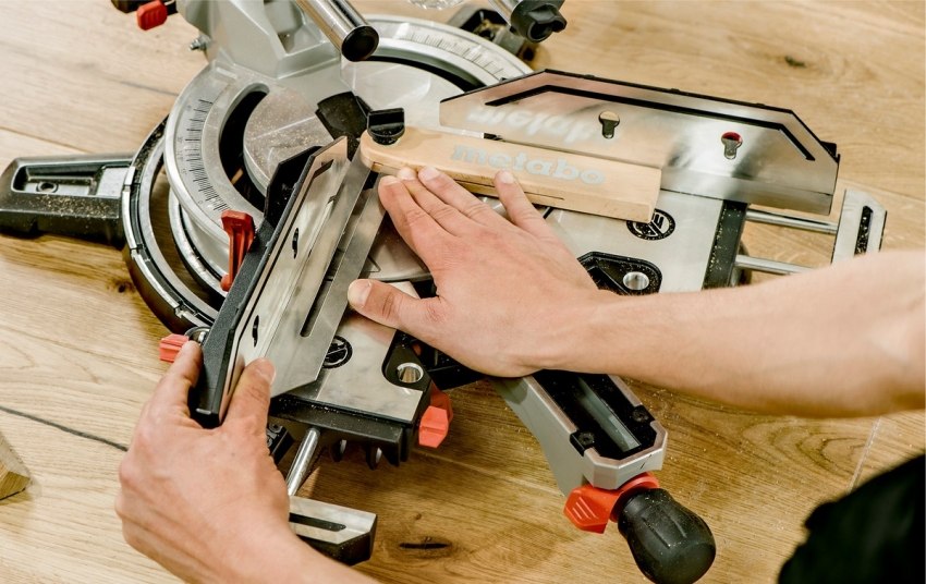 Clamps and stops are used to securely hold the material while the saw is running