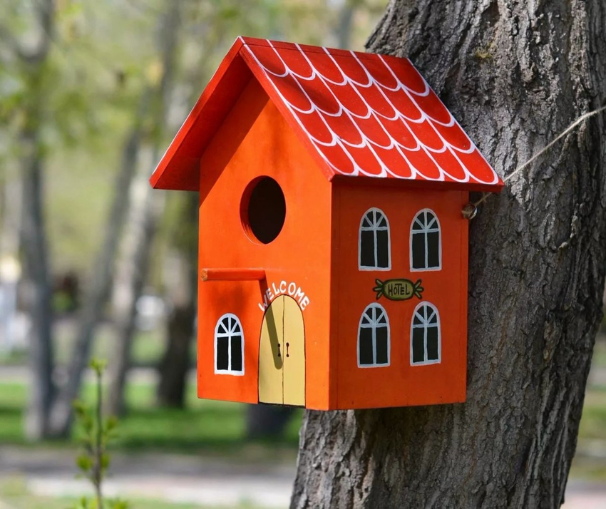 A bird house with a bright and funny design